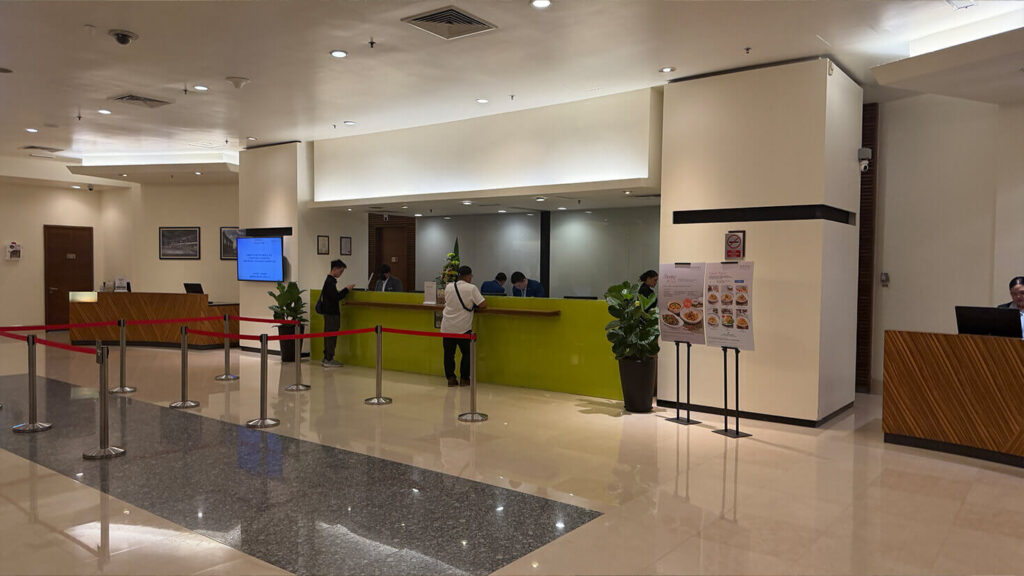 The spacious reception area includes multiple staffed desks and an organised queuing system.